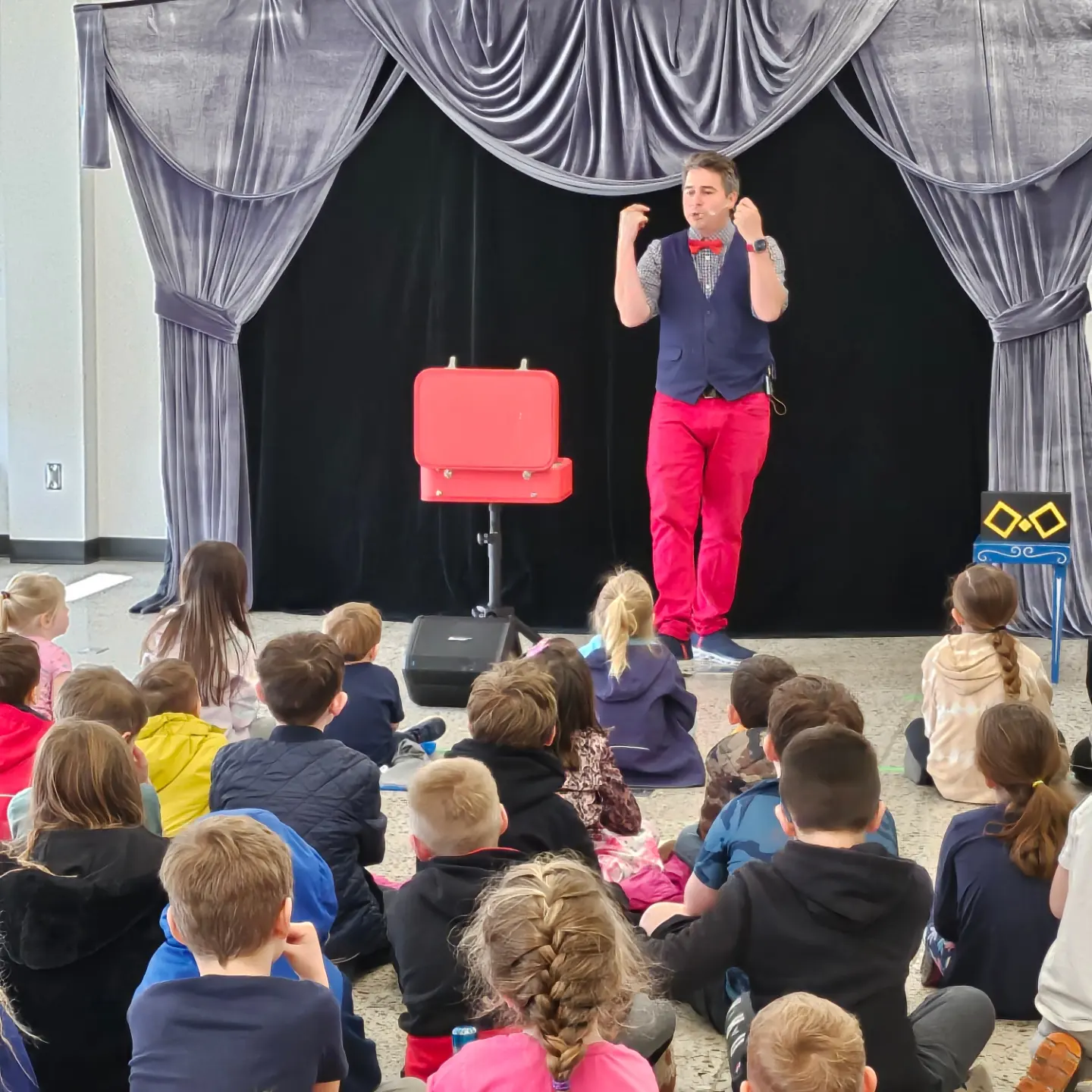 magic show, large crowd with magician at front