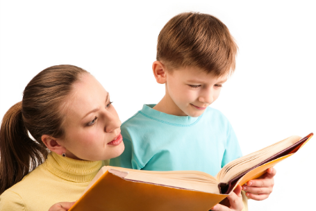 light skinned woman and boy reading a book together