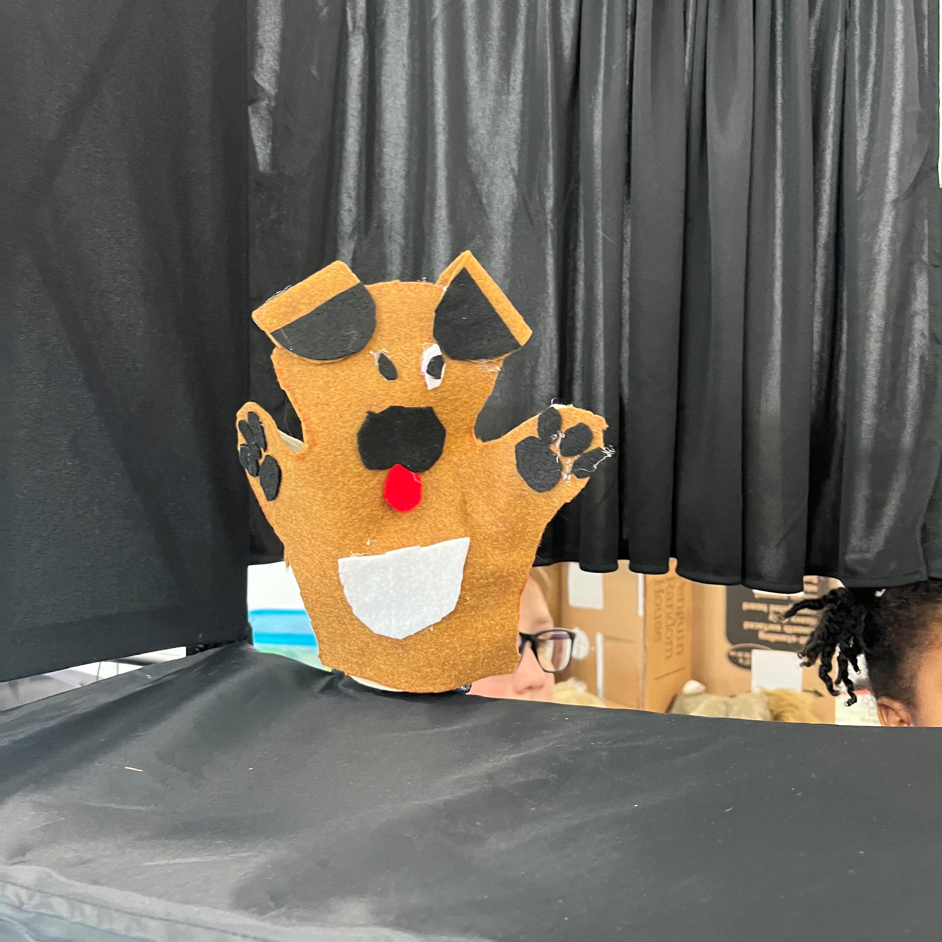 a homemade puppy puppet on the puppet theatre stage